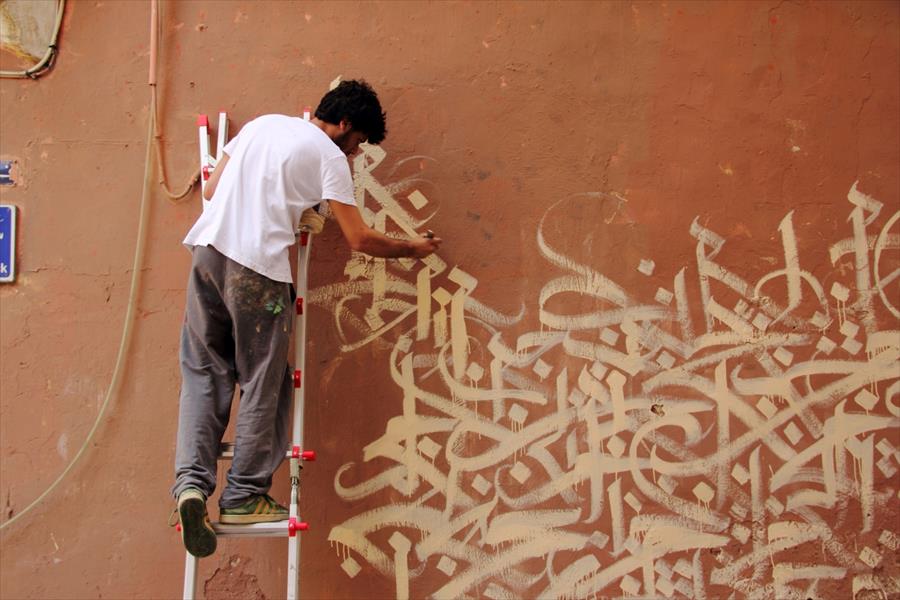 رسام غرافيتي يرسم على جدران شوارع بيروت