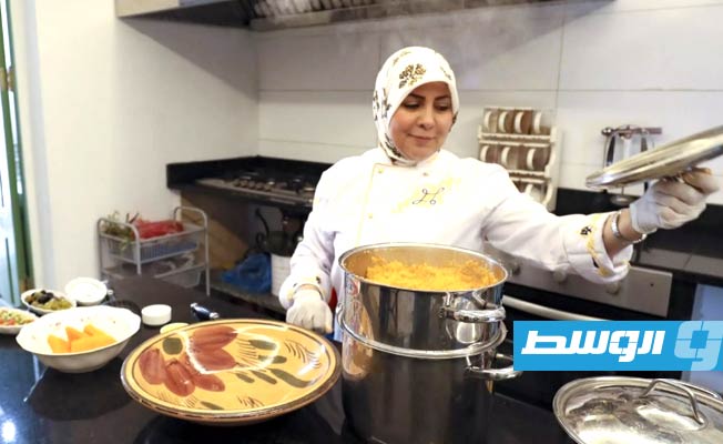 الطاهية الليبية منيرة زويت تعدّ طبقا من الكسكسي في مطبخ مطعمها بطرابلس، 8 مارس 2023 (أ ف ب)