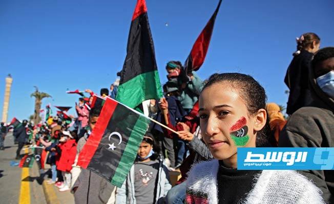 ليبيون يلوحون بالأعلام أثناء تجمعهم في ميدان الشهداء بالعاصمة طرابلس للاحتفال بذكرى ثورة فبراير، 17 فبراير 2021. (أ ف ب)