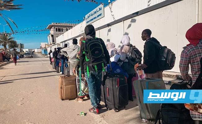 مهاجرون يستعدون للسفر من مطار معيتيقة في طرابلس. (وزارة الداخلية)