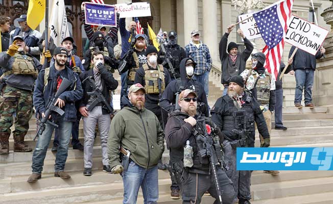 متظاهرون مسلحون بمبنى الكابيتول في ولاية ميشيغان. (أ ف ب)