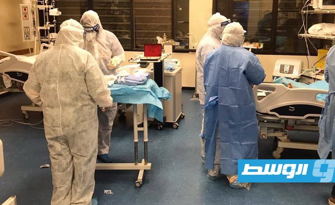 أطباء مركز بنغازي الطبي أثناء إجراء عملية الولادة القيصرية لسيدة مصابة بفيروس كورونا. (المركز)