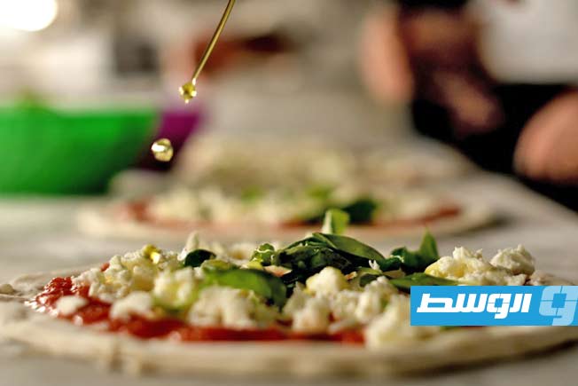 أثناء صناعة بيتزا في السادس من ديسمبر 2017 في مطعم بيتزا سوربيلو في نابولي. (ا ف ب)