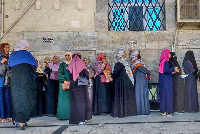 سيدات ليبيات يقفن عند مدخل مصرف تجاري في طرابلس. (البنك الدولي: كتاب ظلال ليبيا)